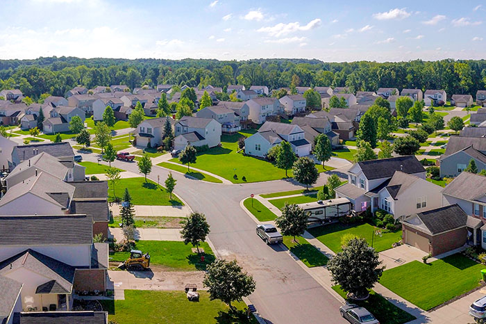 Row of well kept homes in a Northern Michigan HOA community with fresh exterior paint